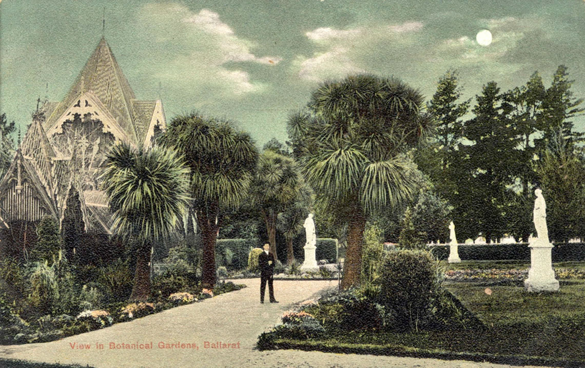 Colour postcard showing statues and man standing on path in botanic gardens