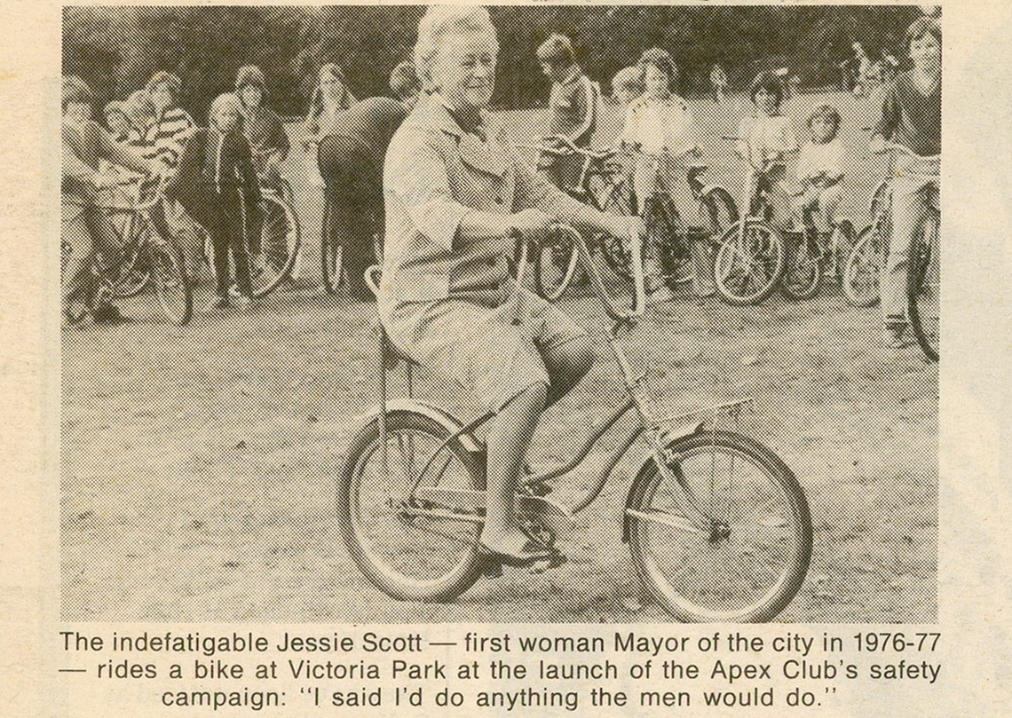 Newspaper clipping showing Mayor Jessie Scott riding bicycle in park